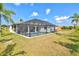 The backyard view showcases a pool with screened enclosure and a well-manicured lawn at 269 Mark Twain Ln, Rotonda West, FL 33947
