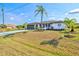 Beautifully landscaped one story home with manicured lawn and new driveway at 269 Mark Twain Ln, Rotonda West, FL 33947