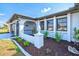 Inviting front exterior with manicured landscaping, a covered entryway, and a two-car garage at 269 Mark Twain Ln, Rotonda West, FL 33947
