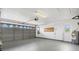 This spacious garage features a gray door with windows, updated epoxy floor and plenty of storage space at 269 Mark Twain Ln, Rotonda West, FL 33947