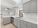 Modern kitchen features gray cabinets, white countertops, and stainless steel appliances at 269 Mark Twain Ln, Rotonda West, FL 33947