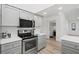 Bright kitchen features stainless steel appliances and light gray cabinets at 269 Mark Twain Ln, Rotonda West, FL 33947