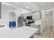 Updated kitchen with gray cabinets, stainless steel appliances, and a breakfast bar at 269 Mark Twain Ln, Rotonda West, FL 33947