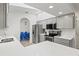Updated kitchen with gray cabinets, stainless steel appliances, and a breakfast bar at 269 Mark Twain Ln, Rotonda West, FL 33947