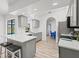 An open kitchen features gray cabinets, quartz countertops, and a breakfast bar at 269 Mark Twain Ln, Rotonda West, FL 33947