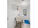 Bright laundry room has overhead cabinets, utility sink with tiled backsplash, with a washing machine and dryer at 269 Mark Twain Ln, Rotonda West, FL 33947