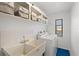 Laundry room features storage, utility sink with tile backsplash, and modern washing machine and dryer at 269 Mark Twain Ln, Rotonda West, FL 33947