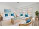 Bright and airy living room with stylish furnishings, neutral colors, and ample natural light at 269 Mark Twain Ln, Rotonda West, FL 33947