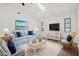 Staged living room with blue accents, skylight and tile floors at 269 Mark Twain Ln, Rotonda West, FL 33947