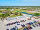 Aerial view showing ample parking near a golf course with a scenic pond, perfect for recreation and convenience at 269 Mark Twain Ln, Rotonda West, FL 33947