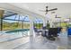 Covered patio with a refreshing swimming pool, gas fire pit, and outdoor seating for year-round enjoyment at 269 Mark Twain Ln, Rotonda West, FL 33947