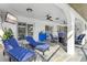 Relaxing covered patio with ceiling fans, lounging furniture, with a television for outdoor entertainment at 269 Mark Twain Ln, Rotonda West, FL 33947