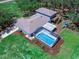 Aerial view of a home featuring a screened-in pool, deck, and playground at 27215 Crosby Rd, Myakka City, FL 34251