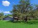 Rustic barn set against a backdrop of lush greenery and a bright blue sky at 27215 Crosby Rd, Myakka City, FL 34251