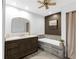 Bathroom featuring a vanity with stone countertop, large tub, and elegant fixtures at 27215 Crosby Rd, Myakka City, FL 34251