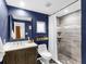 Modern bathroom with dark blue walls, tiled shower, and elegant fixtures at 27215 Crosby Rd, Myakka City, FL 34251