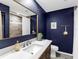 Bathroom featuring a vanity with stone countertop, walk-in shower, and elegant fixtures at 27215 Crosby Rd, Myakka City, FL 34251