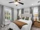 Bright bedroom featuring a neutral color scheme, ceiling fan, and two windows at 27215 Crosby Rd, Myakka City, FL 34251