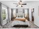 Bright bedroom featuring a neutral color scheme, ceiling fan, and two windows at 27215 Crosby Rd, Myakka City, FL 34251