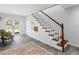 Welcoming entryway with stylish staircase, neutral rug, and ample natural light at 27215 Crosby Rd, Myakka City, FL 34251