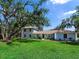 Charming two-story home with a sprawling lawn and mature trees offering curb appeal at 27215 Crosby Rd, Myakka City, FL 34251