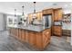Spacious kitchen with a large center island, stainless steel appliances, and wood cabinets at 27215 Crosby Rd, Myakka City, FL 34251