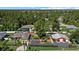 Aerial view of a sprawling property with a home, large garage, and lush green landscaping at 2769 Dode Ave, North Port, FL 34288