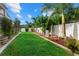 Spacious backyard features well-manicured lawn, mature landscaping, and privacy fencing at 2769 Dode Ave, North Port, FL 34288