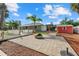 Well-maintained backyard featuring patio, fire pit, lawn, shed, and lush landscaping at 2769 Dode Ave, North Port, FL 34288