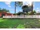 Spacious backyard featuring large trees, green grass, and red shed at 2769 Dode Ave, North Port, FL 34288
