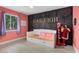 Charming bedroom with wood accent wall, a bed with drawers, and pink decor at 2769 Dode Ave, North Port, FL 34288