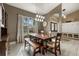 Elegant dining area with wooden table, decorative lighting fixture, and a large window at 2769 Dode Ave, North Port, FL 34288
