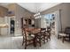 Stylish dining room with a wooden table, modern lighting, and a view of the outdoors at 2769 Dode Ave, North Port, FL 34288