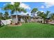 Charming single-story home with manicured lawn, decorative stone accents, and lush landscaping at 2769 Dode Ave, North Port, FL 34288