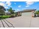 Home exterior featuring a stone facade, green garage door, and a spacious driveway at 2769 Dode Ave, North Port, FL 34288