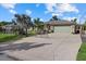 Exterior view of the home showcasing a paved driveway, stone accents, and a well-manicured lawn at 2769 Dode Ave, North Port, FL 34288
