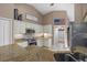Kitchen features white cabinets, granite countertops, stainless appliances and an eat in bar at 2769 Dode Ave, North Port, FL 34288