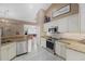 Kitchen view shows eat-in bar, countertops, and stainless steel appliances in an open concept at 2769 Dode Ave, North Port, FL 34288