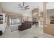 Open-concept living room with tile floors, modern ceiling fan, and a leather sofa at 2769 Dode Ave, North Port, FL 34288