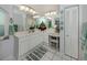 Bathroom with double sinks, vanity, and large mirrors, offering ample counter space and storage at 304 Rosewood Ct, Venice, FL 34293
