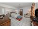 Spacious bedroom features tile flooring, a ceiling fan, and neutral color palette at 304 Rosewood Ct, Venice, FL 34293