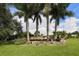 Lake of the Woods community sign surrounded by palm trees and lush landscaping at 304 Rosewood Ct, Venice, FL 34293