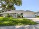 Charming one-story home with well-manicured lawn and colorful landscaping at 304 Rosewood Ct, Venice, FL 34293