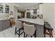 Kitchen island featuring quartz countertop with bar seating, gray cabinets, and stainless steel appliances at 304 Rosewood Ct, Venice, FL 34293