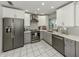 Modern kitchen with stainless steel appliances and gray-and-white cabinetry at 304 Rosewood Ct, Venice, FL 34293