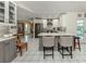 Open kitchen with gray and white cabinets, stainless steel appliances, and an island with bar seating at 304 Rosewood Ct, Venice, FL 34293