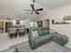 Open living space with tile flooring, a ceiling fan, and easy access to the kitchen at 304 Rosewood Ct, Venice, FL 34293