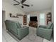 Living room with a modern ceiling fan, tile floors, and neutral walls at 304 Rosewood Ct, Venice, FL 34293