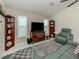 Bright living room with a large TV, tile floors, and a comfortable leather sofa at 304 Rosewood Ct, Venice, FL 34293