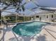 Backyard kidney-shaped pool surrounded by a screened-in lanai at 304 Rosewood Ct, Venice, FL 34293